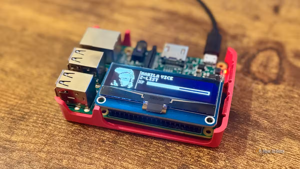 The finished Raspberry Pi Tamagotchi displaying a character on its tiny OLED screen