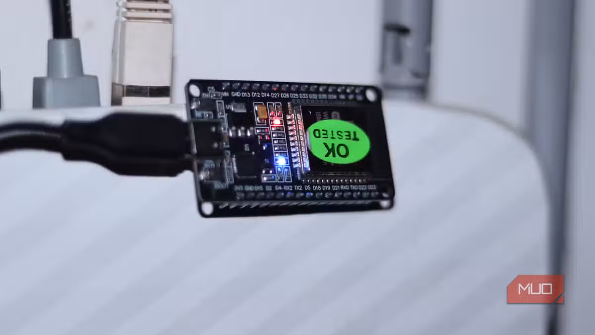 An ESP32 running NAT router firmware perched on a standard home router