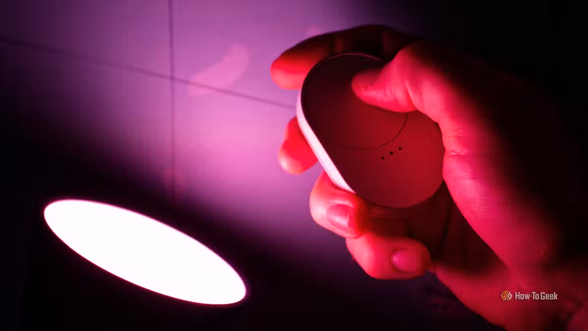 The IKEA BILRESA remote controlling a Tradfri light, small enough for any nightstand.