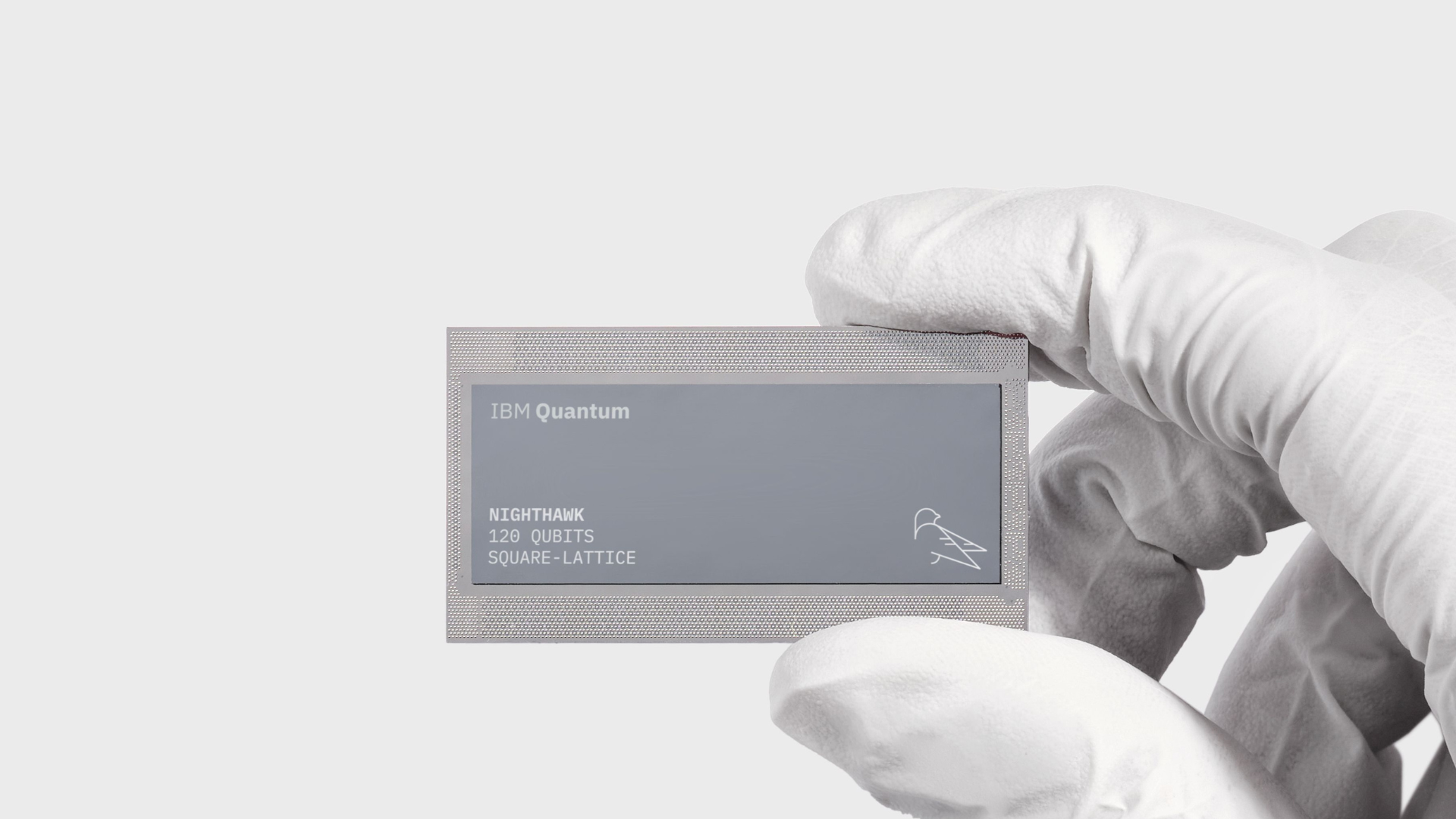 An IBM Quantum Nighthawk chip held by a gloved hand.