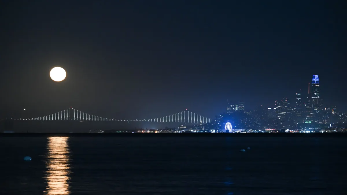 The full moon rises over San Francisco Bay with Alcatraz in shadow. Photo by Tayfun Coskun/Anadolu via Getty Images