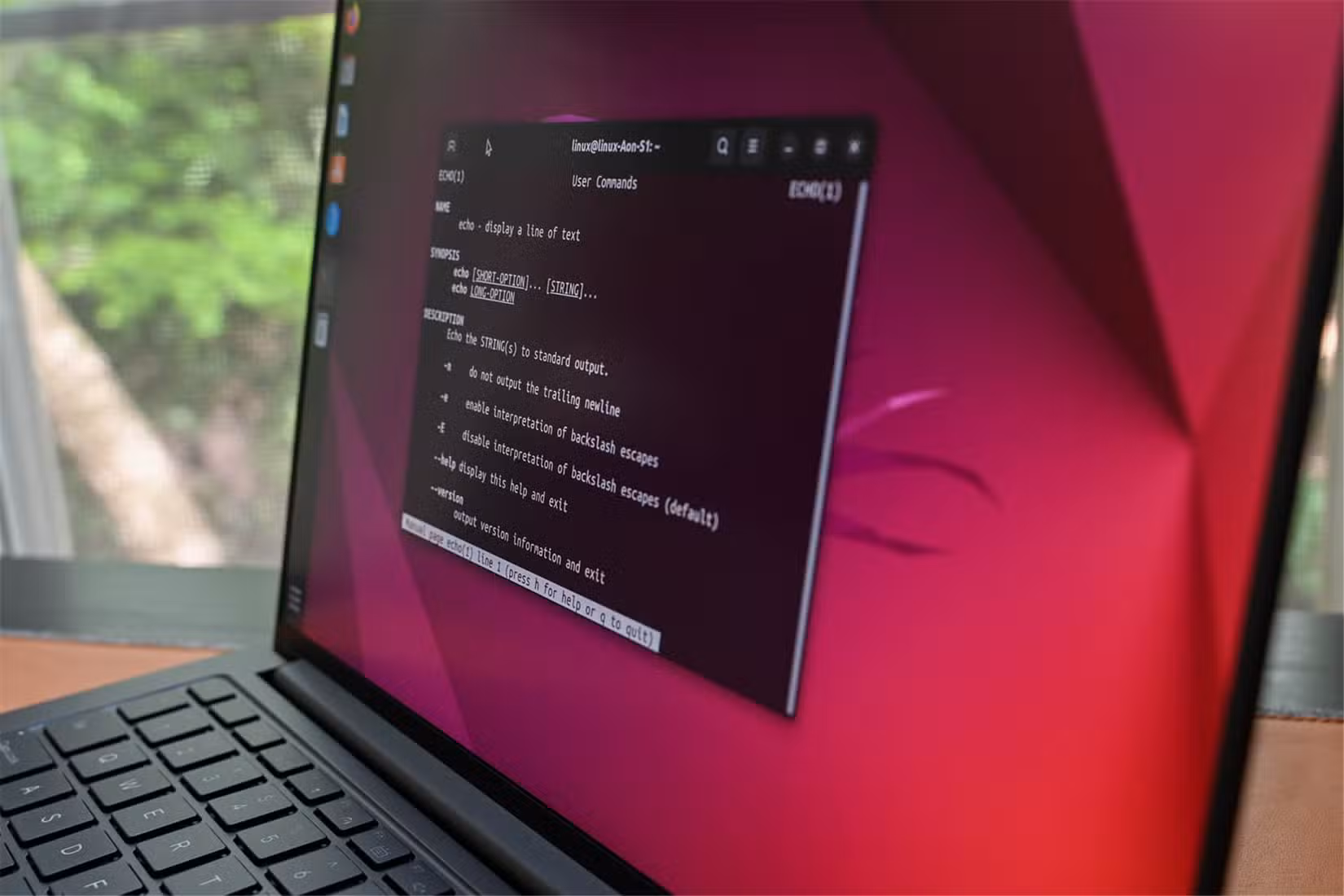A laptop running Ubuntu, showing the manual for a terminal command. 
