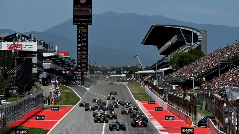 Racers speed down a straightaway  during F1